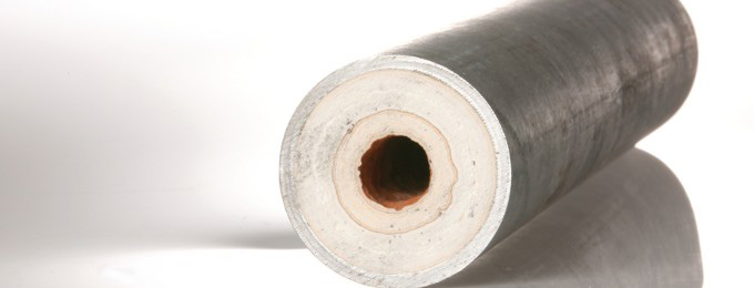 Limescale buildup inside a pipe reducing the pipe's internal diameter